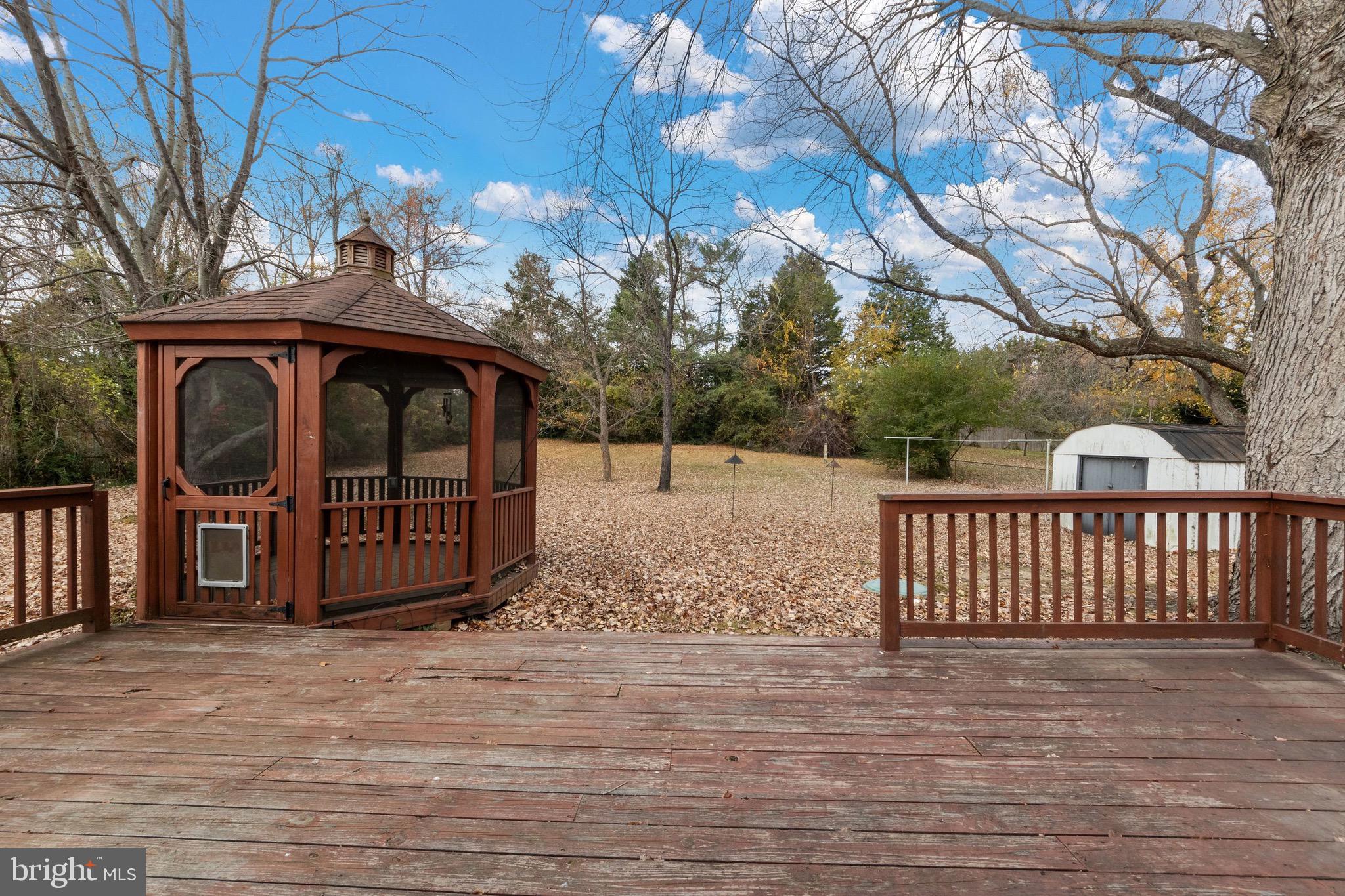 115 Valley View Avenue Edgewater, MD 21037 - Photo 40 of 56 a view of backyard with large trees and wooden fence