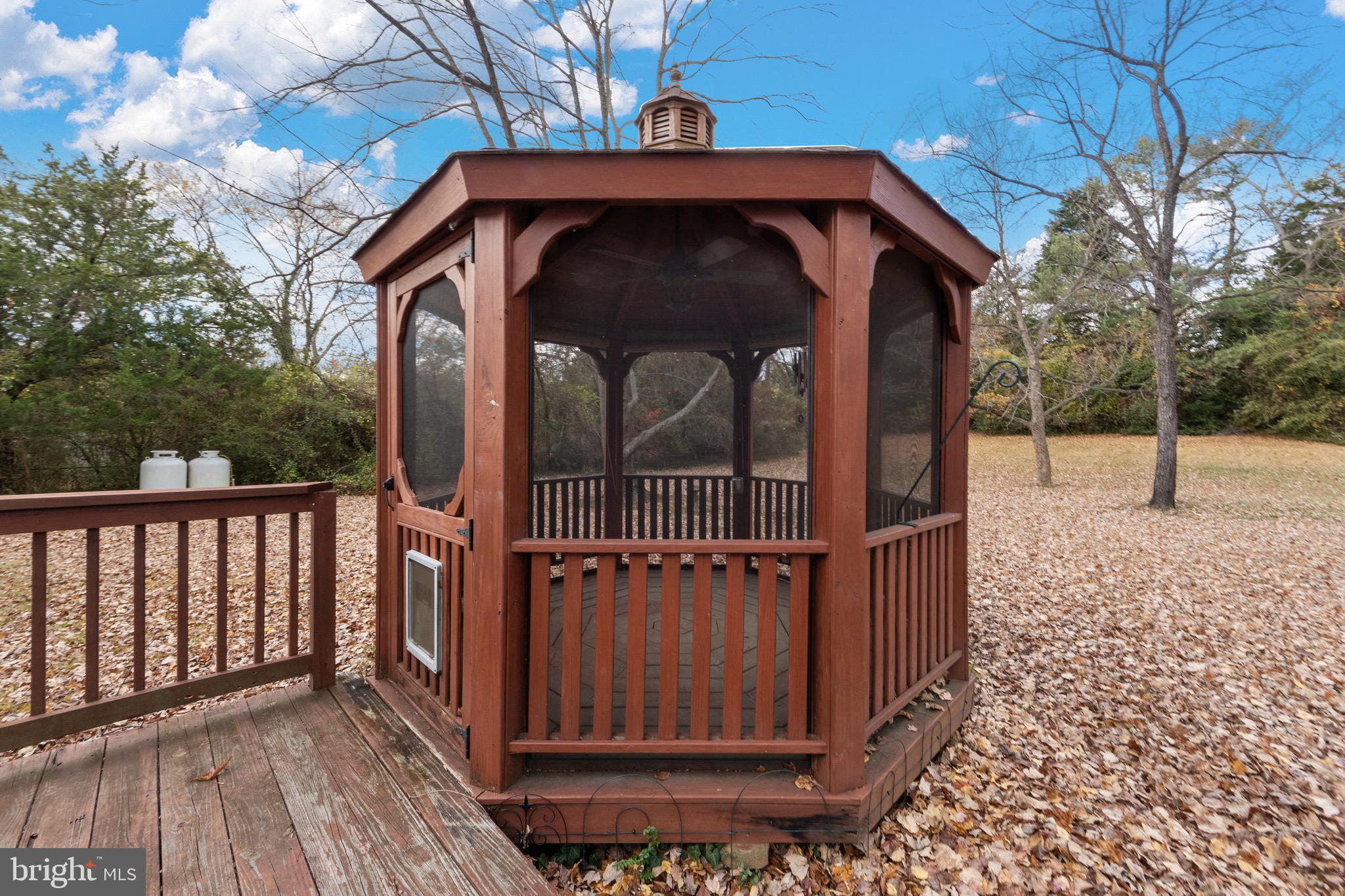115 Valley View Avenue Edgewater, MD 21037 - Photo 44 of 56 a view of a wooden house with a small yard
