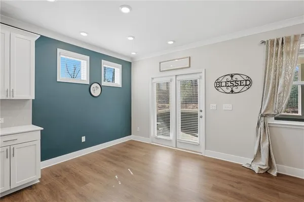 a view of a dining room with furniture and wooden floor