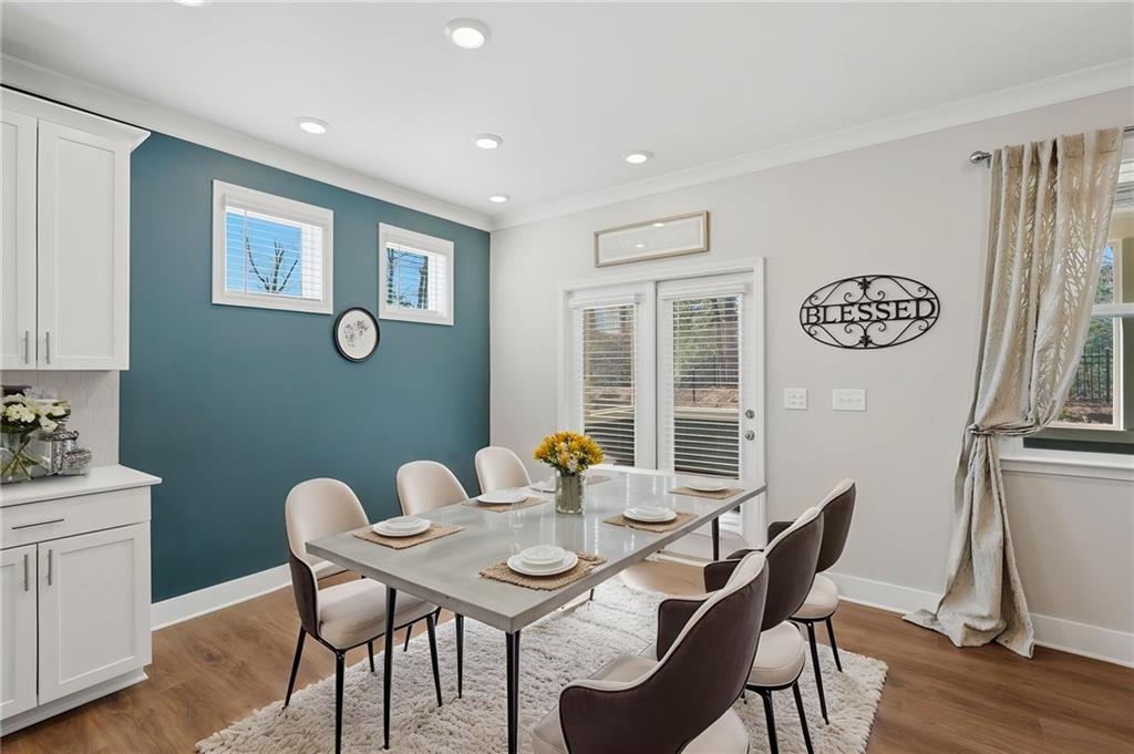 1413 Bluffs Ridge Way Canton, GA 30114 - Photo 16 of 62 a view of a dining room with furniture and wooden floor