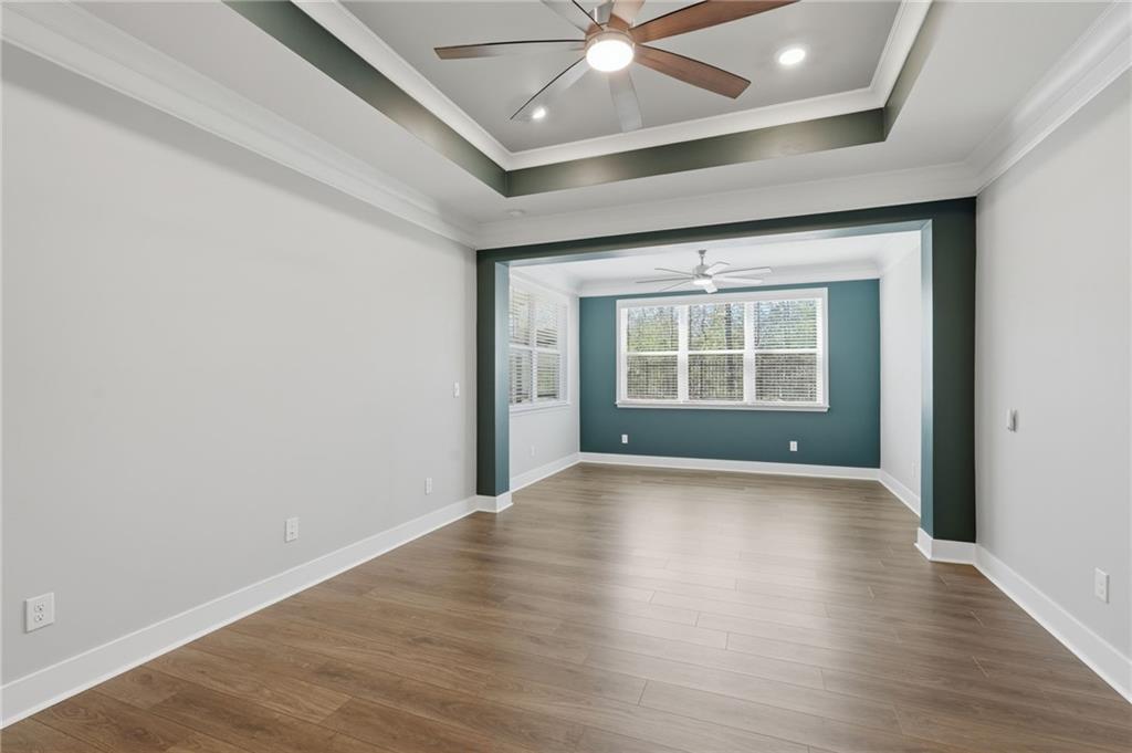 1413 Bluffs Ridge Way Canton, GA 30114 - Photo 18 of 62 wooden floor in an empty room with a window
