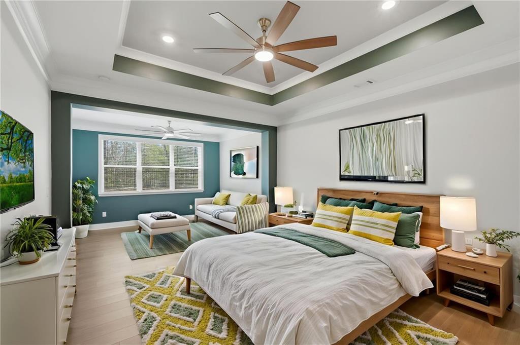 1413 Bluffs Ridge Way Canton, GA 30114 - Photo 19 of 62 a spacious bedroom with a bed a couch and a potted plant