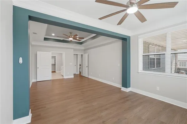 a view of empty room with wooden floor