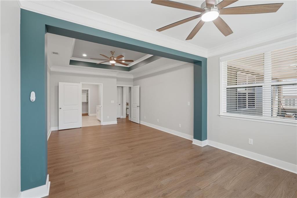1413 Bluffs Ridge Way Canton, GA 30114 - Photo 21 of 62 a view of an empty room with wooden floor and a window