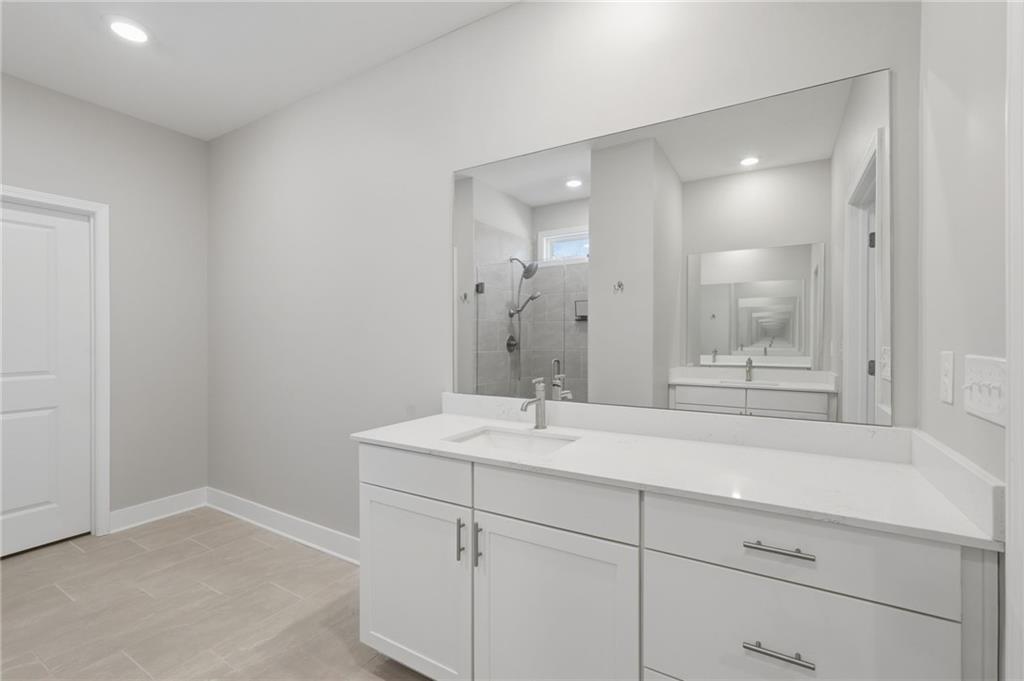 1413 Bluffs Ridge Way Canton, GA 30114 - Photo 23 of 62 a bathroom with a sink and a mirror