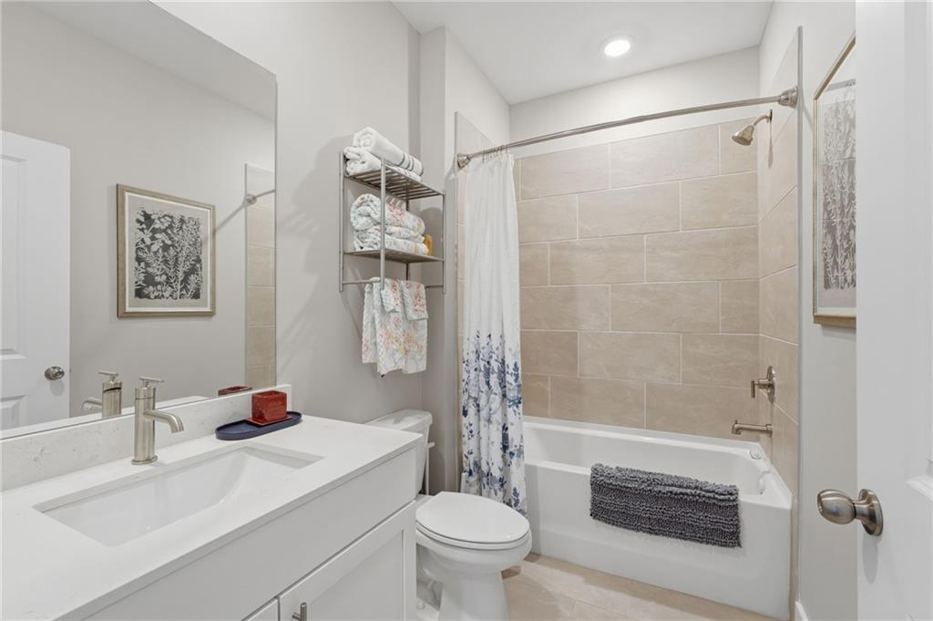 1413 Bluffs Ridge Way Canton, GA 30114 - Photo 28 of 62 a bathroom with a sink toilet and shower