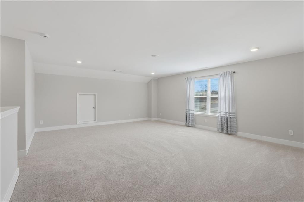 1413 Bluffs Ridge Way Canton, GA 30114 - Photo 29 of 62 an empty room with windows and pillars in it