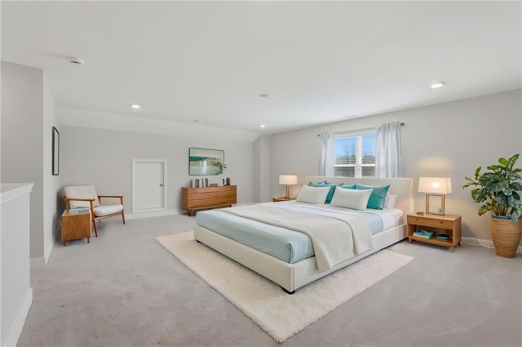 1413 Bluffs Ridge Way Canton, GA 30114 - Photo 30 of 62 a spacious bedroom with a bed and a couch
