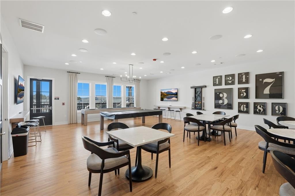 1413 Bluffs Ridge Way Canton, GA 30114 - Photo 51 of 62 a view of a dining room with furniture and wooden floor
