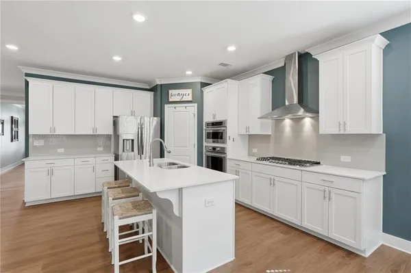 a kitchen with a sink stove and cabinets