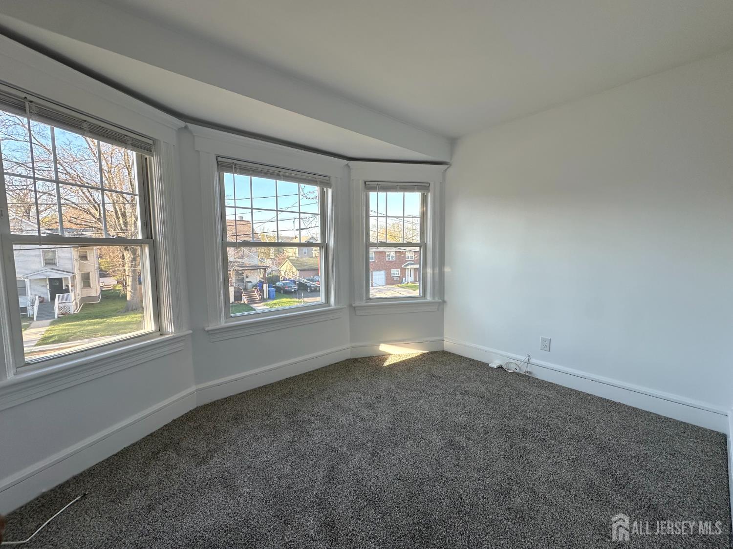 511 Grove Street Dunellen, NJ 08812 - Photo 5 of 9 an empty room with windows
