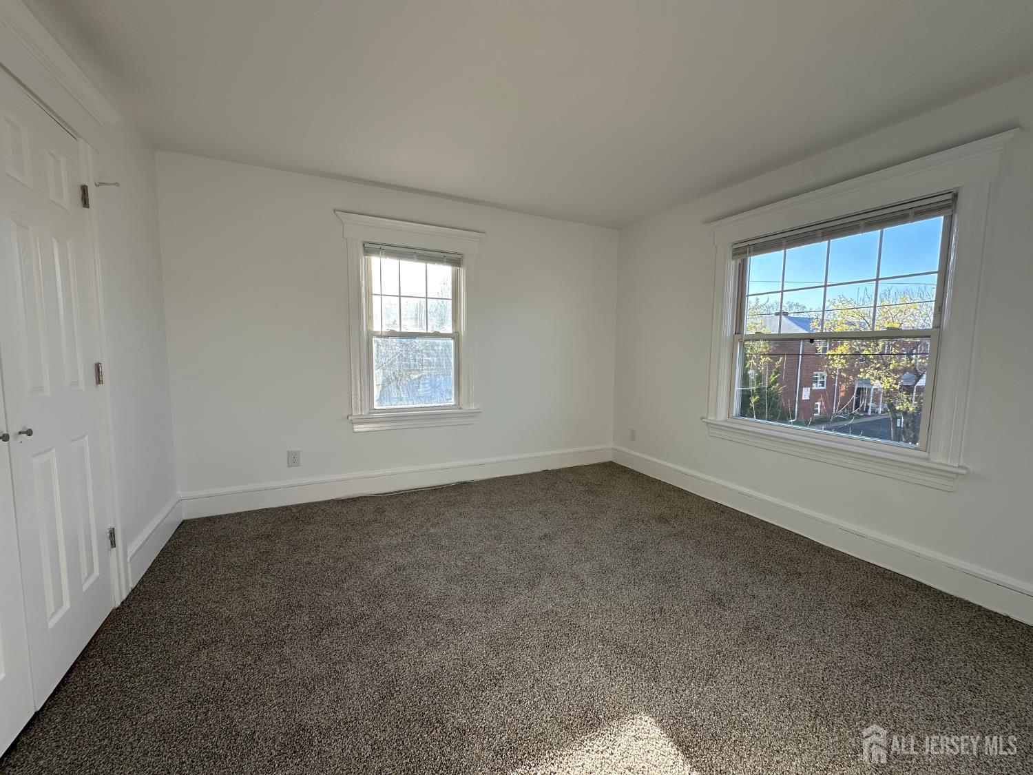 511 Grove Street Dunellen, NJ 08812 - Photo 6 of 9 an empty room with windows