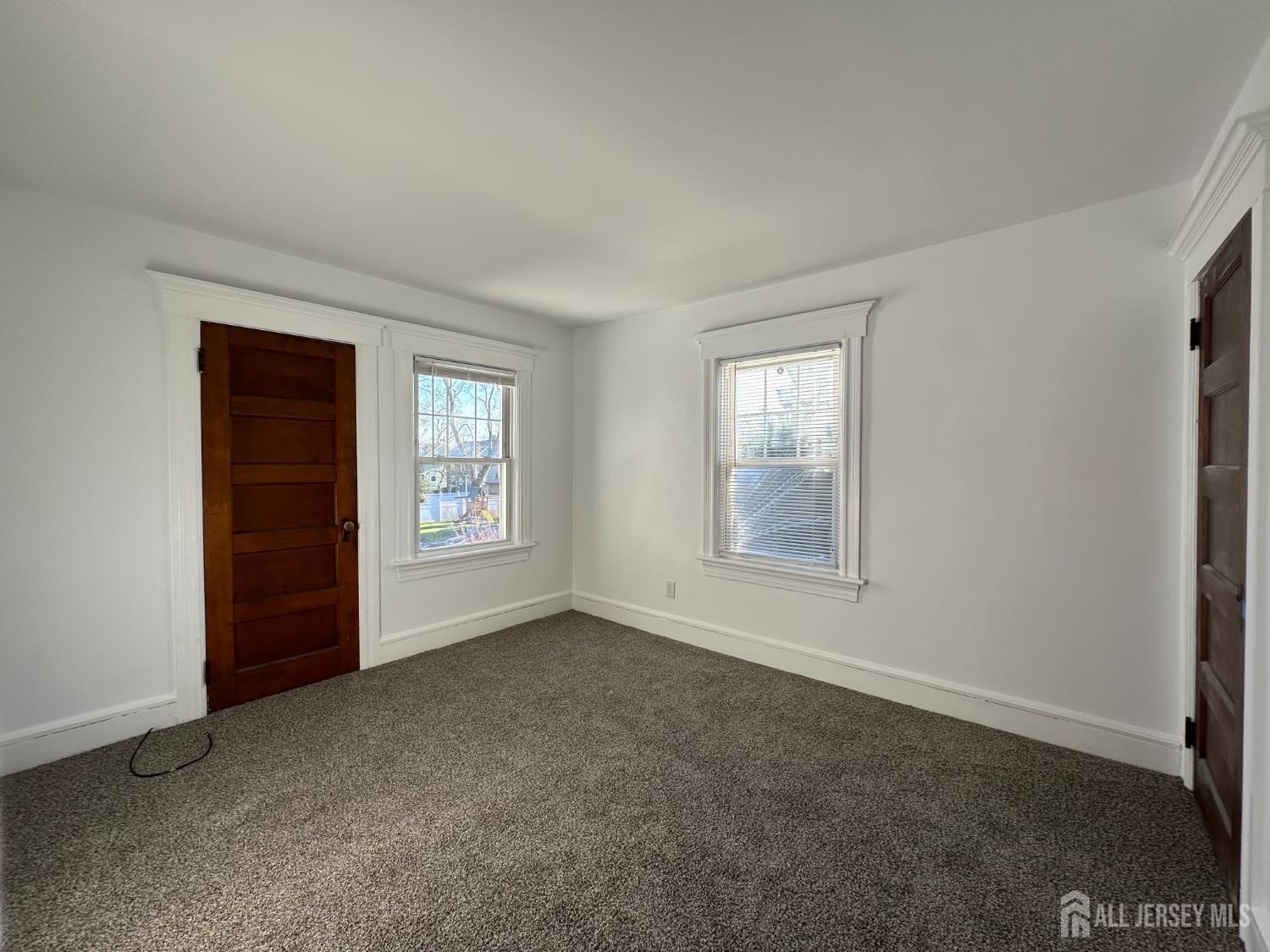 511 Grove Street Dunellen, NJ 08812 - Photo 7 of 9 an empty room with windows