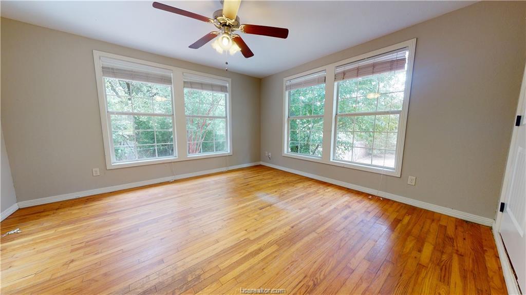 4309 Old College Road Bryan, TX 77801 - Photo 7 of 9 a view of an empty room with wooden floor and a window