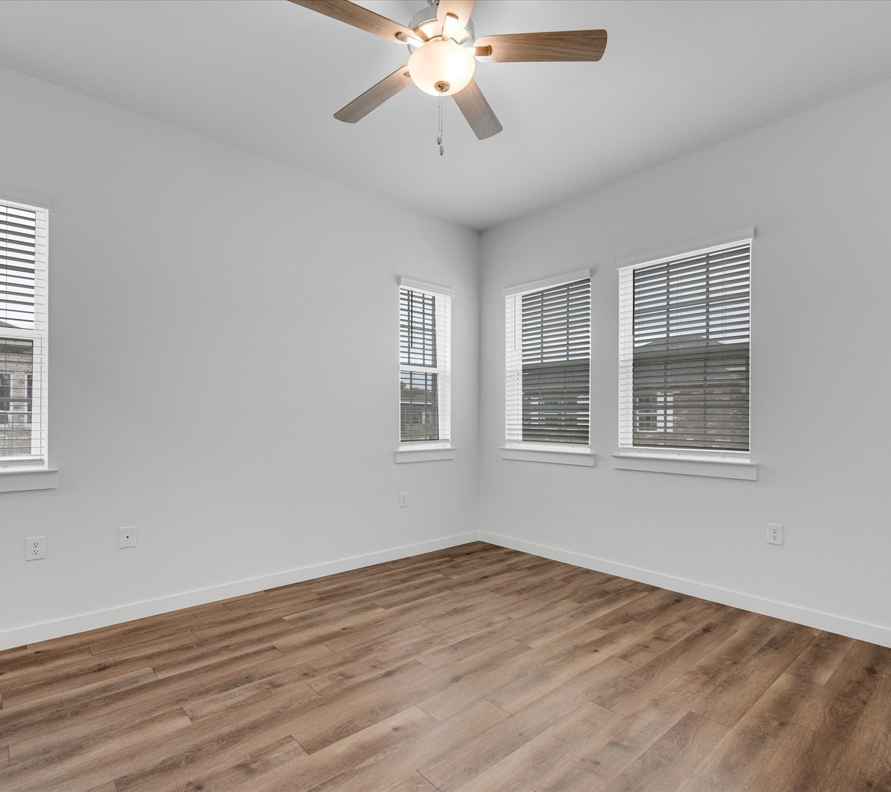 2703-806 Rockhill Road McKinney, TX 75072 - Photo 7 of 14 a view of an empty room with wooden floor and a window