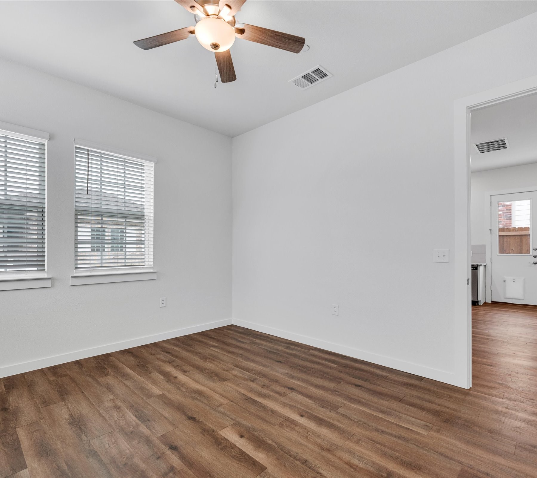 2703-806 Rockhill Road McKinney, TX 75072 - Photo 9 of 14 wooden floor in an empty room with a window