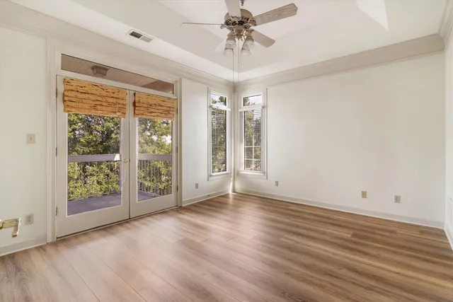 a view of hallway with stairs and wooden floor