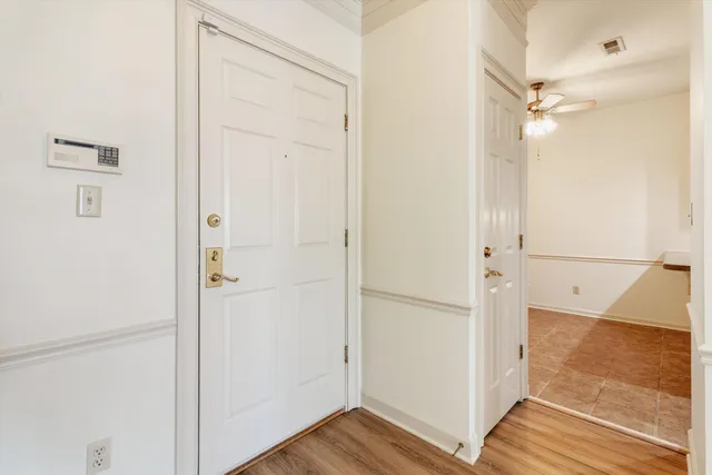 a view of a hallway with wooden floor