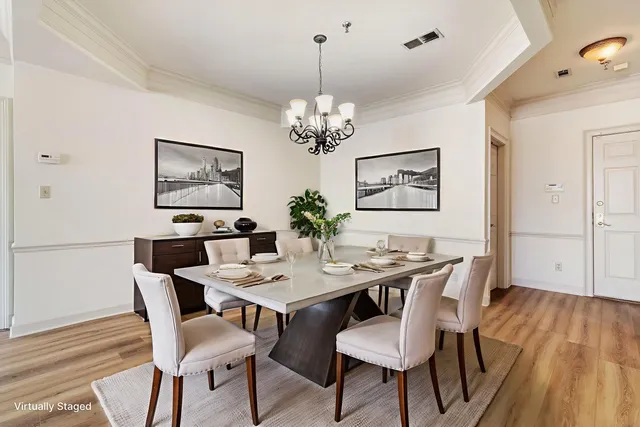 a view of a room with wooden floor and a ceiling fan