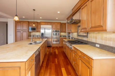 a kitchen with stove and cabinets