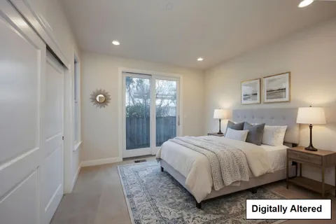 a room with white cabinets and wooden floors