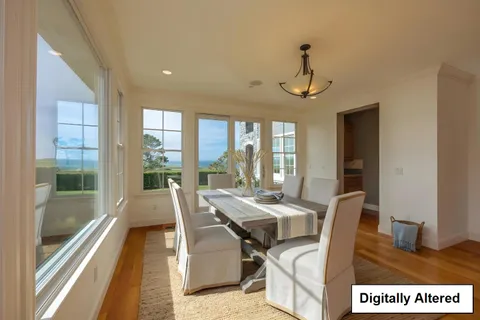 a view of a dining room with furniture wooden floor a livingroom and chandelier