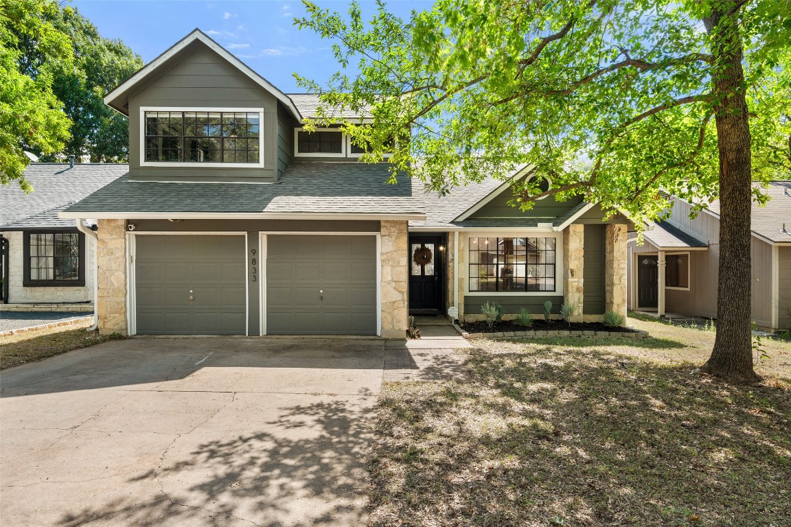 9833 Briar Ridge Drive Austin, TX 78748 - Photo 1 of 29 a front view of a house with a garden