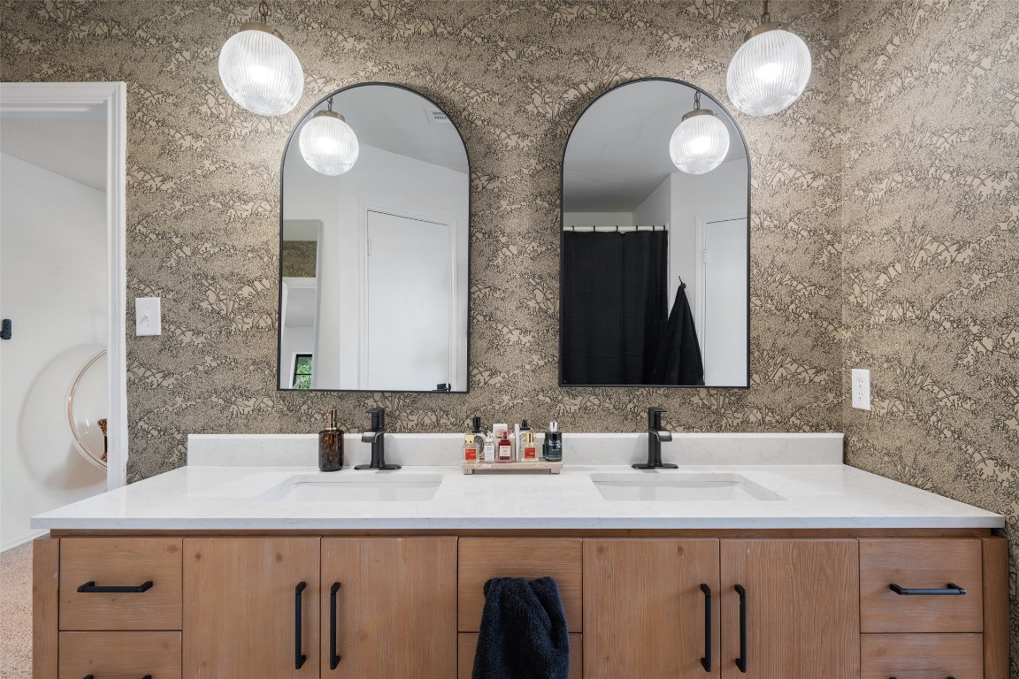 9833 Briar Ridge Drive Austin, TX 78748 - Photo 16 of 29 a bathroom with double vanity sinks and a mirror