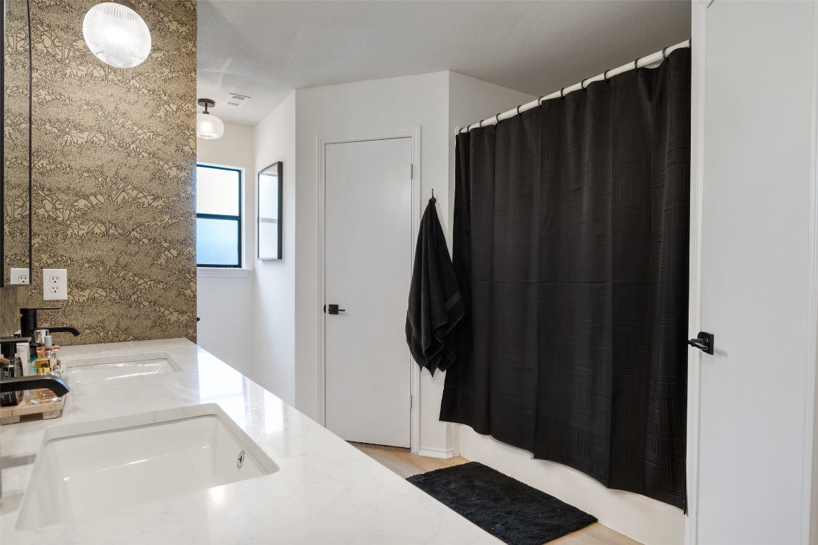 9833 Briar Ridge Drive Austin, TX 78748 - Photo 18 of 29 a bathroom with a bathtub and a shower