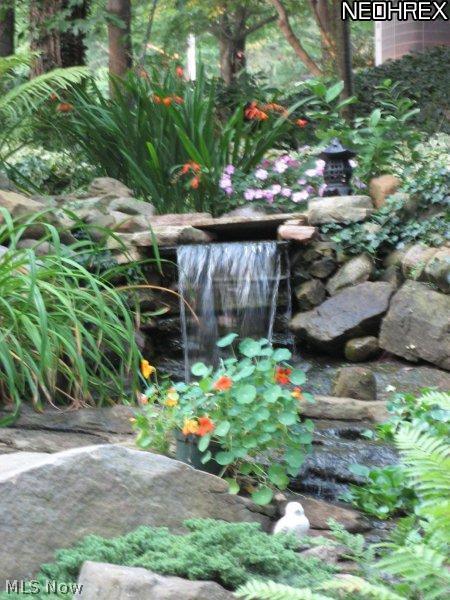 4846 Ranchwood Road Akron, OH 44333 - Photo 20 of 23 Enjoy the cascading waterfall into a koi pond from the brick patio.