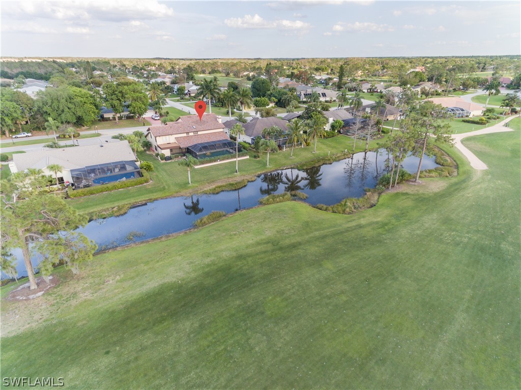 an aerial view of residential houses with outdoor space and swimming pool
