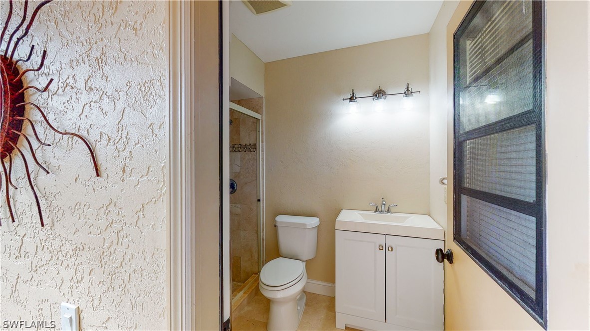 14565 Eagle Ridge Drive Fort Myers, FL 33912 - Photo 15 of 28 a bathroom with a toilet and a shower