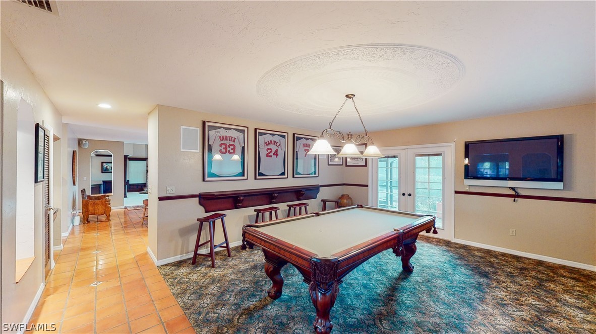 14565 Eagle Ridge Drive Fort Myers, FL 33912 - Photo 16 of 28 a living room with furniture a table and a flat screen tv