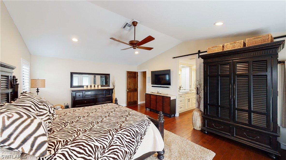 14565 Eagle Ridge Drive Fort Myers, FL 33912 - Photo 19 of 28 a bedroom with a bed and a flat screen tv