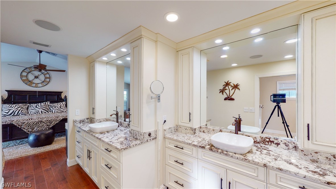 14565 Eagle Ridge Drive Fort Myers, FL 33912 - Photo 20 of 28 a bathroom with a granite countertop sink and a mirror