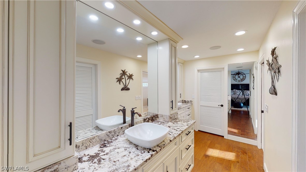 14565 Eagle Ridge Drive Fort Myers, FL 33912 - Photo 21 of 28 a bathroom with a granite countertop sink and a mirror