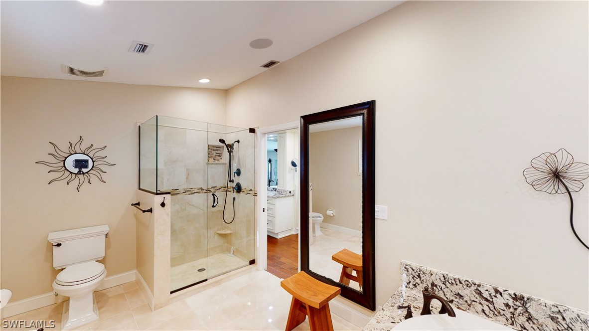 14565 Eagle Ridge Drive Fort Myers, FL 33912 - Photo 22 of 28 a bathroom with a shower sink mirror and toilet