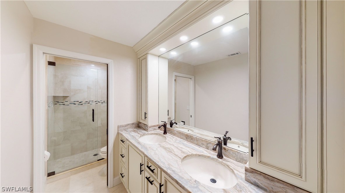 14565 Eagle Ridge Drive Fort Myers, FL 33912 - Photo 24 of 28 a bathroom with a double vanity sink mirror and shower