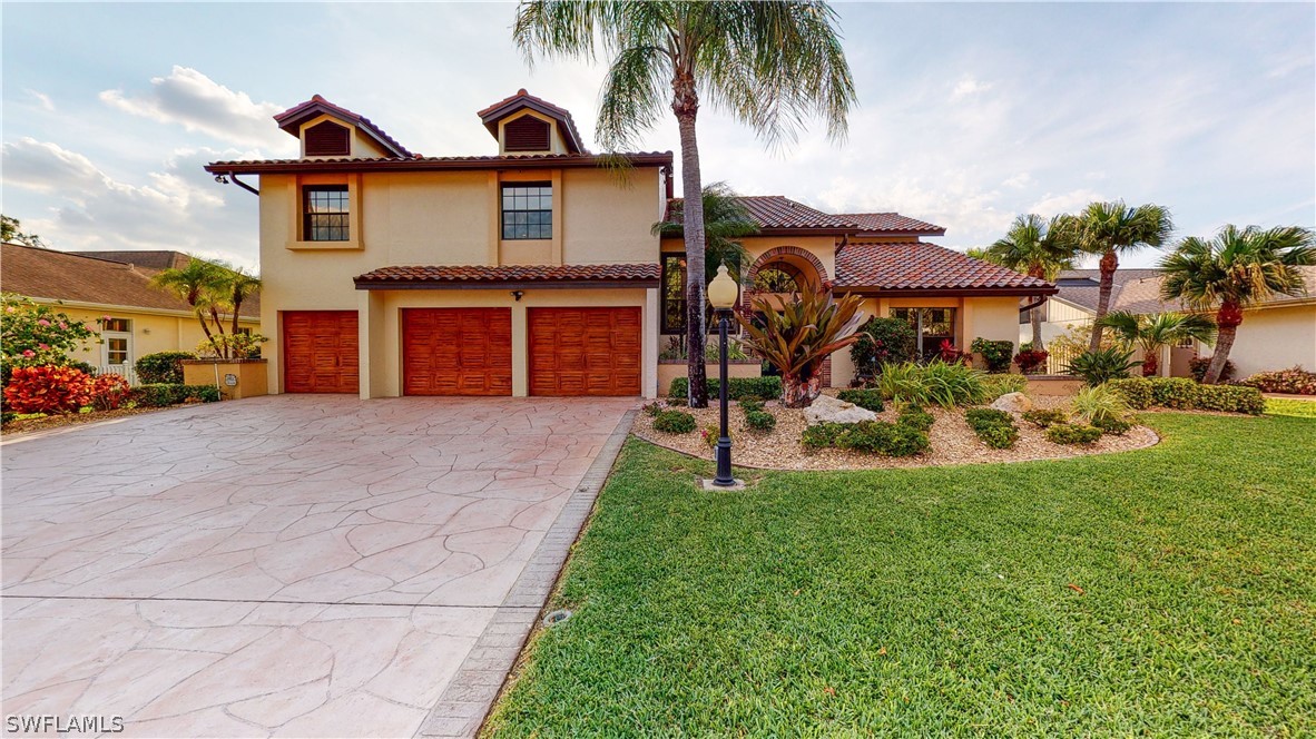 14565 Eagle Ridge Drive Fort Myers, FL 33912 - Photo 6 of 28 a front view of a house with a yard and garage