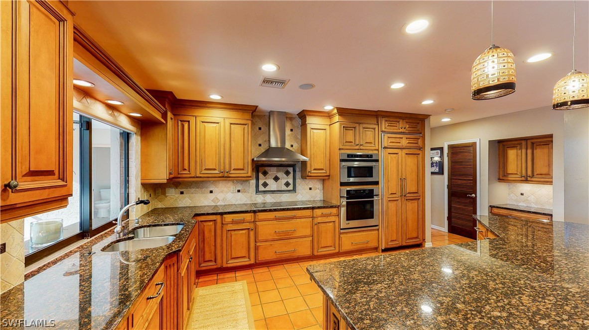 14565 Eagle Ridge Drive Fort Myers, FL 33912 - Photo 7 of 28 a kitchen with stainless steel appliances granite countertop a sink and cabinets