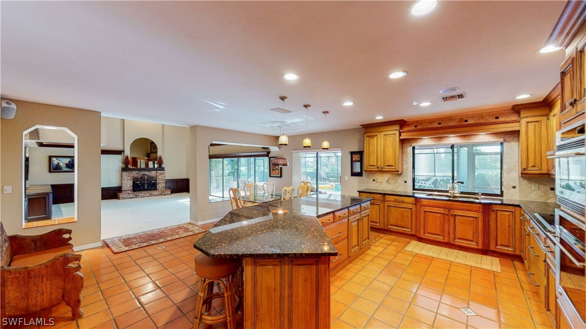 14565 Eagle Ridge Drive Fort Myers, FL 33912 - Photo 8 of 28 a dining hall with stainless steel appliances granite countertop a sink and couches