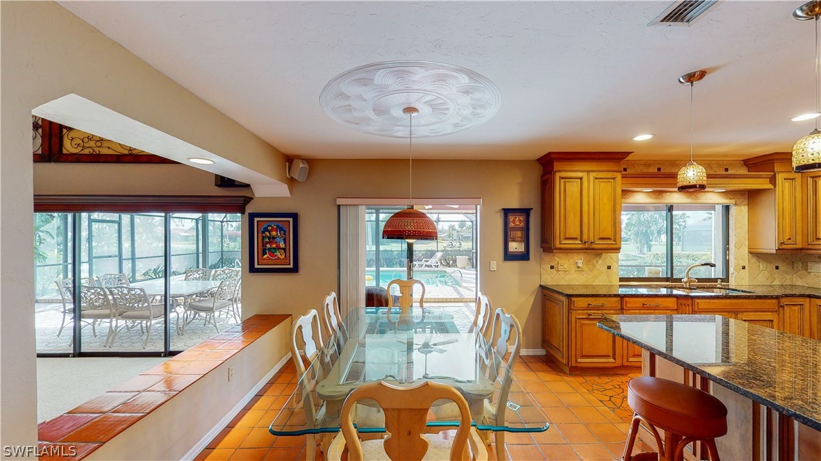 14565 Eagle Ridge Drive Fort Myers, FL 33912 - Photo 10 of 28 a dining room with furniture a chandelier and wooden floor