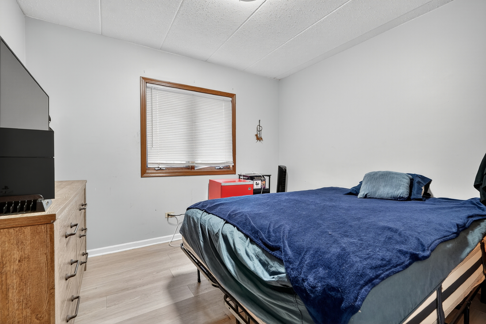 10630 Ridgeland Avenue, Unit 1B Chicago Ridge, IL 60415 - Photo 14 of 22 a bedroom with a bed and a flat screen tv