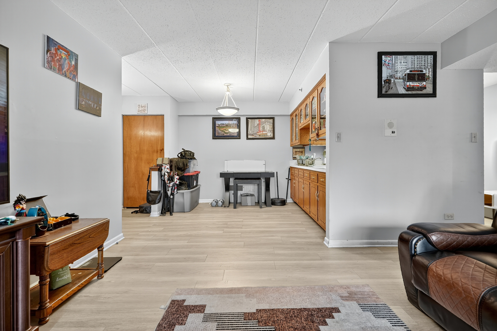 10630 Ridgeland Avenue, Unit 1B Chicago Ridge, IL 60415 - Photo 8 of 22 a living room with furniture and a flat screen tv