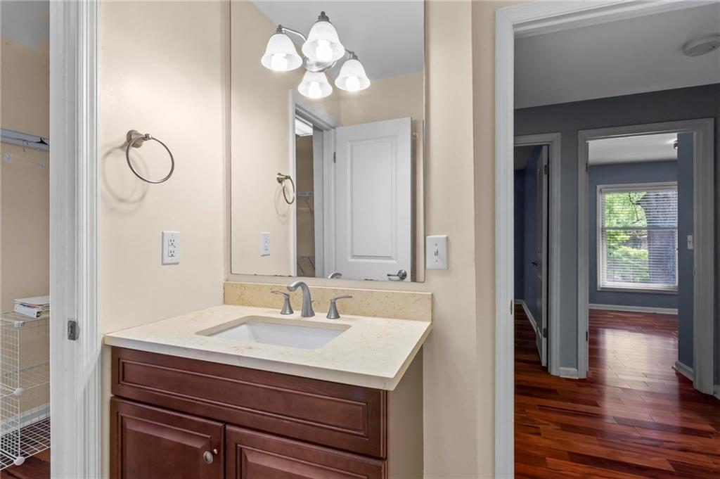 3650 Ashford Dunwoody Road Northeast, Unit 227 Atlanta, GA 30319 - Photo 17 of 23 a bathroom with a sink a light fixture and a mirror
