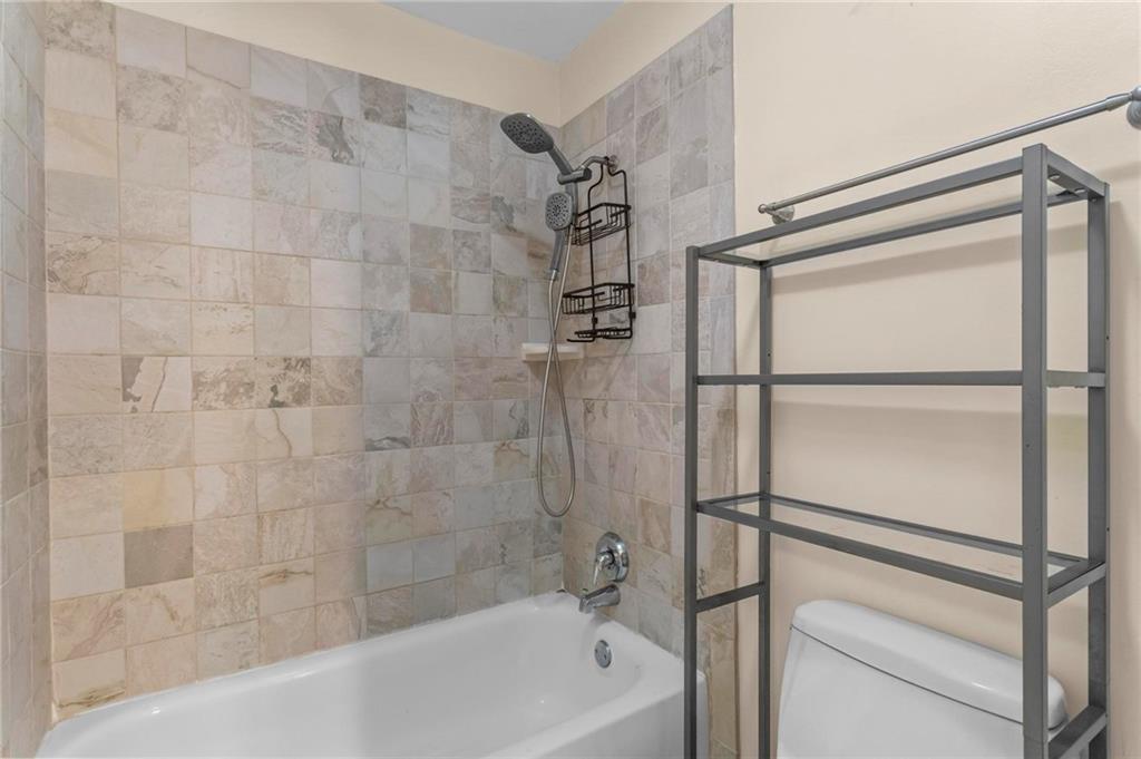 3650 Ashford Dunwoody Road Northeast, Unit 227 Atlanta, GA 30319 - Photo 18 of 23 a bathroom with a bathtub