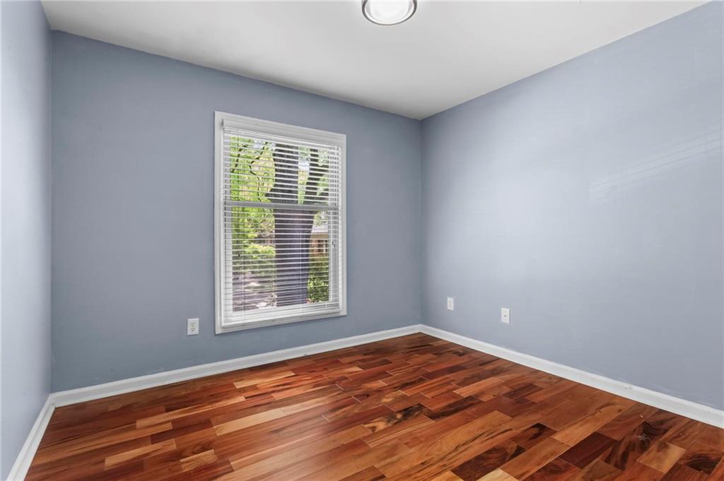 3650 Ashford Dunwoody Road Northeast, Unit 227 Atlanta, GA 30319 - Photo 19 of 23 a view of empty room with wooden floor and fan