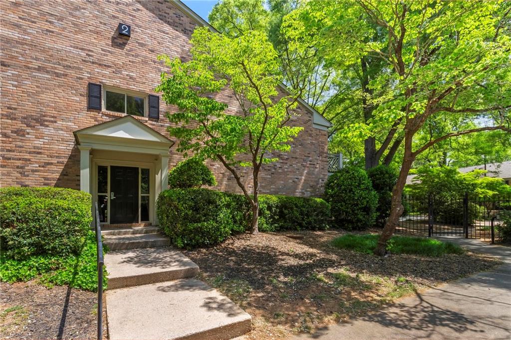 3650 Ashford Dunwoody Road Northeast, Unit 227 Atlanta, GA 30319 - Photo 2 of 23 a front view of a house with garden