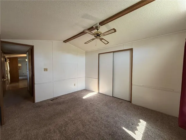 a view of empty room with ceiling fan