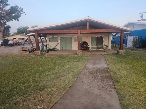 a front view of a house with swimming pool having outdoor seating